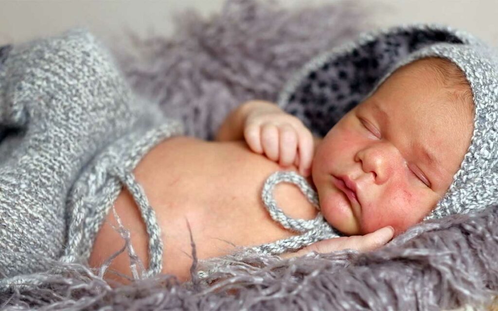 newborn-baby-in-blue-blanket-sleeping