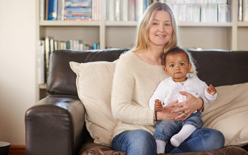 happy-nanny-with-baby-on-lap