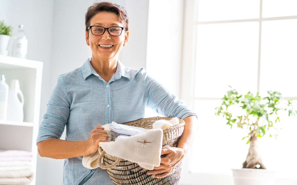 happy-housekeeper-with-laundry