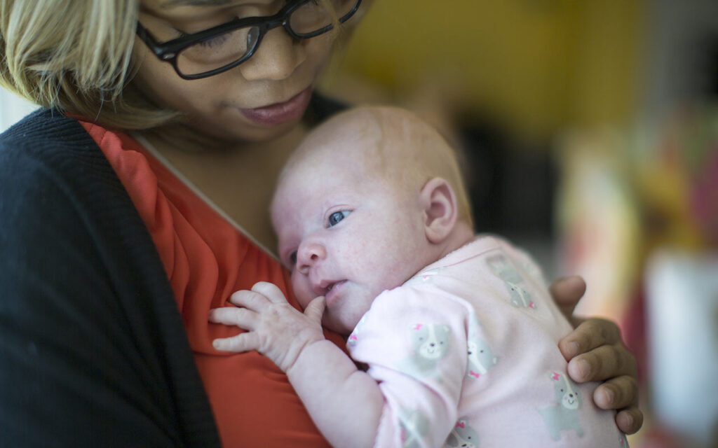 nanny-holding-newborn