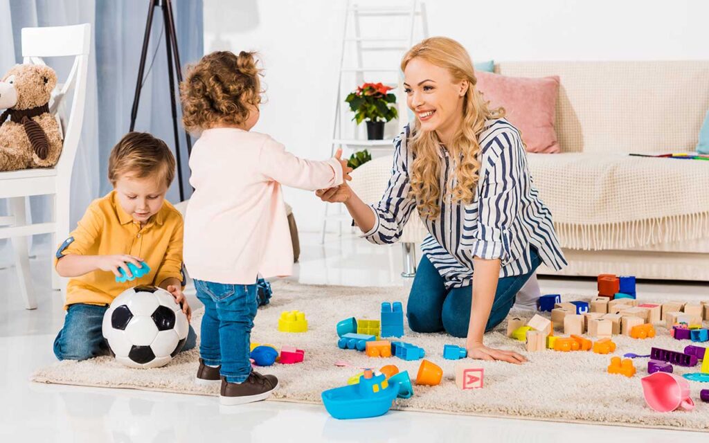 happy-nanny-playing-with-toddlers